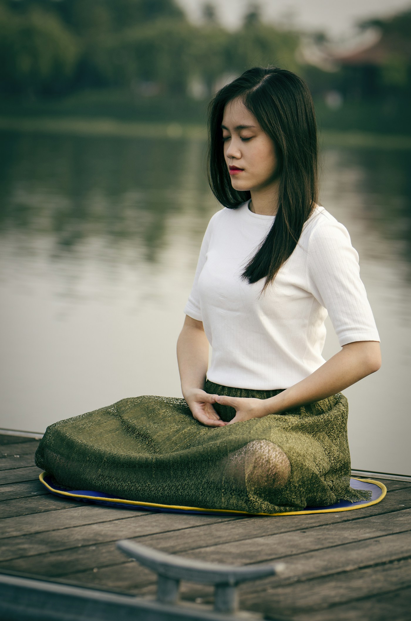 Peaceful seated meditation by the water at golden hour